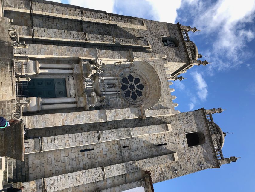 Porto: Guided City Walking Tour & Port Wine Cellar - Entering 19th-century Port wine producers