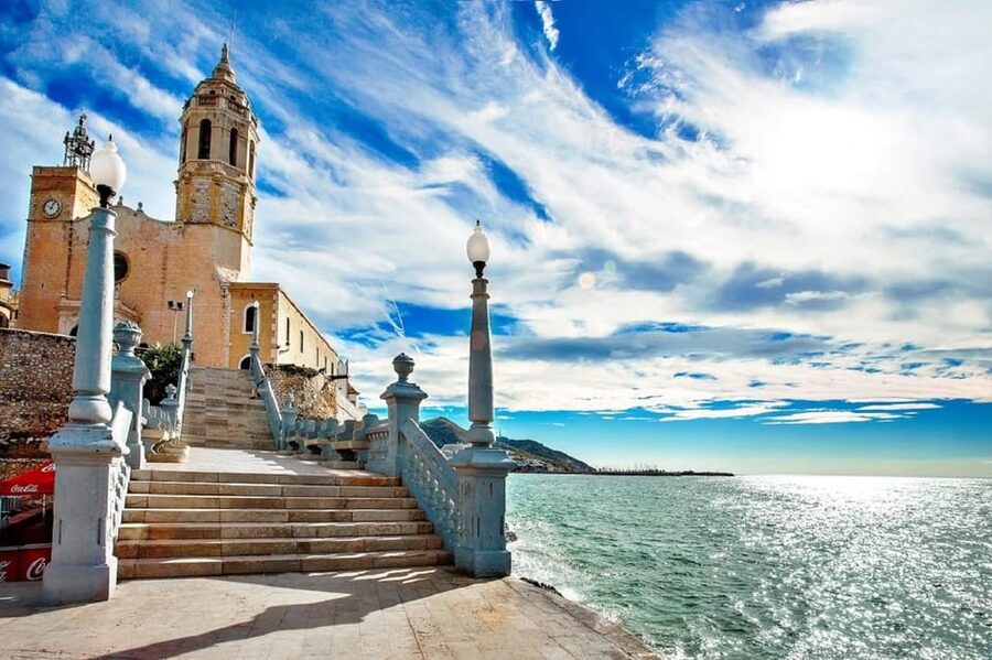 Sitges: Sailboat trip + walking tour and wine cellar tour - Walking from the waterfront into old Sitges